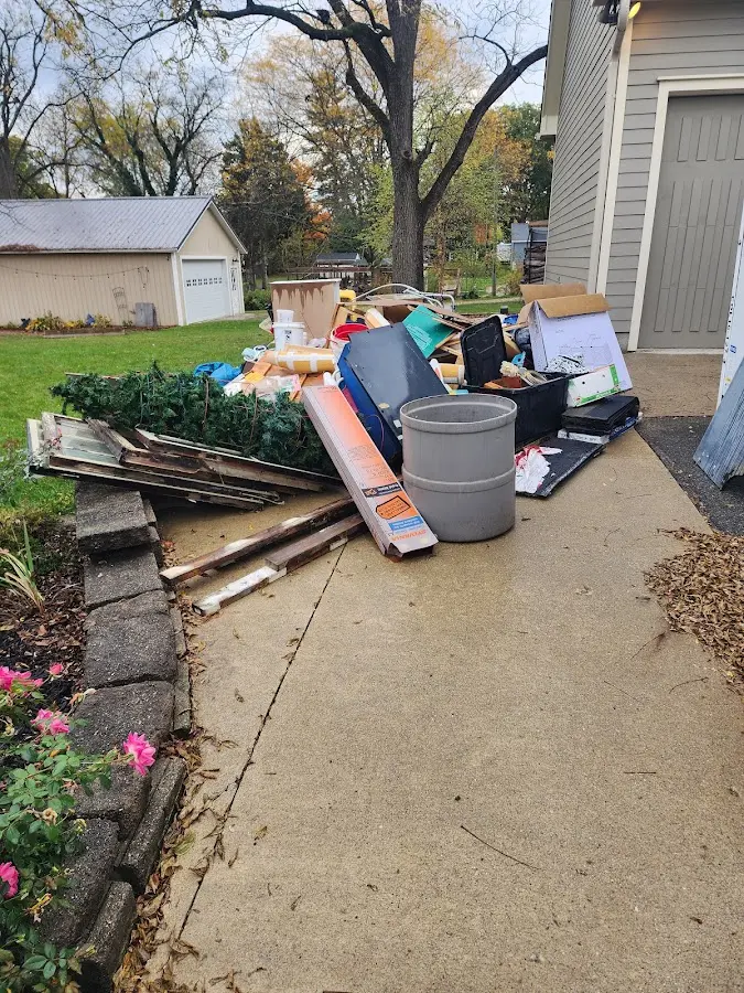 Dumpster being loaded with debris for 3 Yard Dumpster Rental in Oak Creek